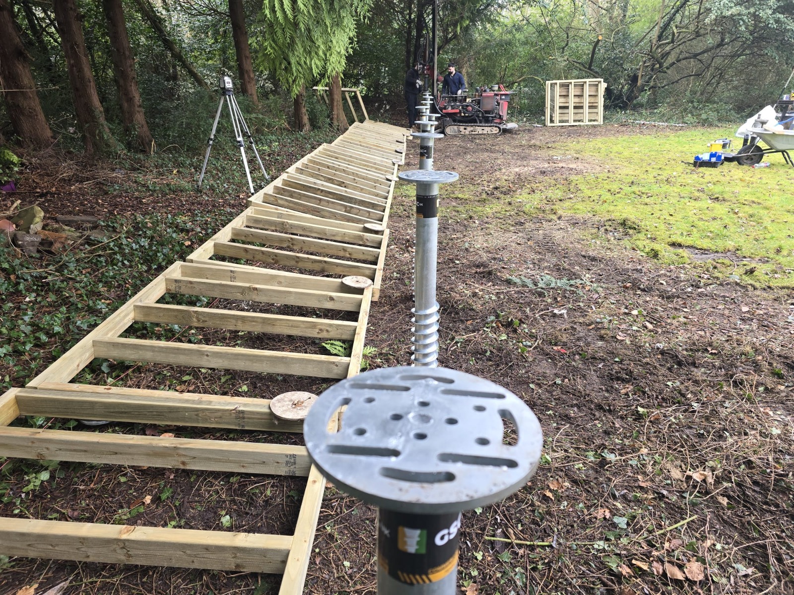Installing 90 ground screws for a garden room